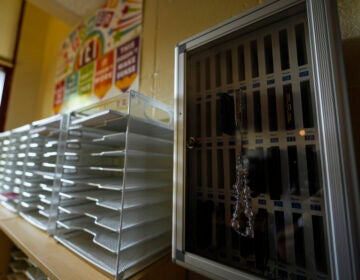 Cell phones sit inside of a cell phone locker at a school