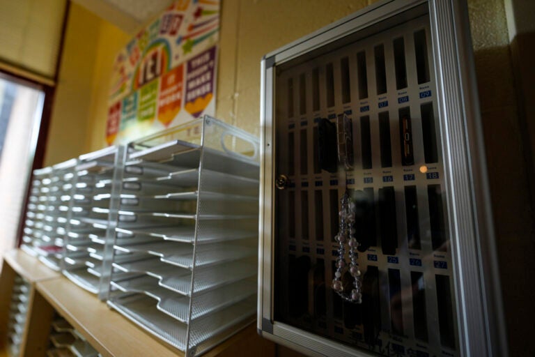 Cellphones in Schools Cell phones sit inside of a cell phone locker at a school