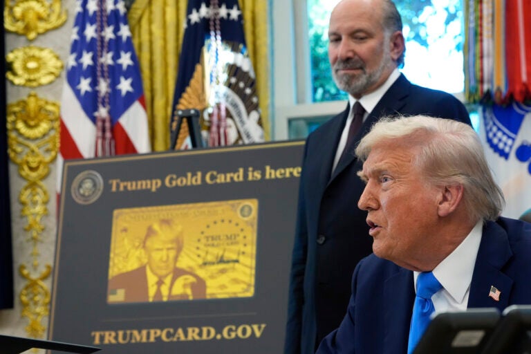 President Donald Trump speaks as Commerce Secretary Howard Lutnick listens in the Oval Office of the White House