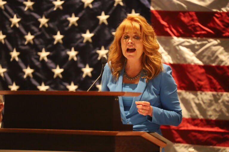 State treasurer Stacy Garrity speaks at the Pennsylvania Republican Party’s fall meeting with an American flag behind her