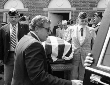 Members of various veteran organizations carry flag-draped casket of J.B. Ralph from funeral home in Williamstown, Pennsylvania