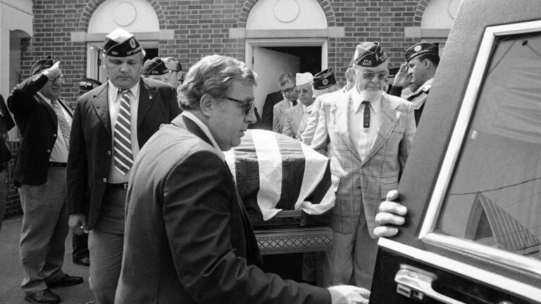 Members of various veteran organizations carry flag-draped casket of J.B. Ralph from funeral home in Williamstown, Pennsylvania
