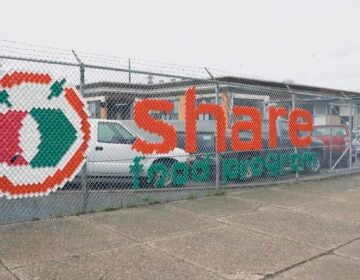 Share food logo program on fence