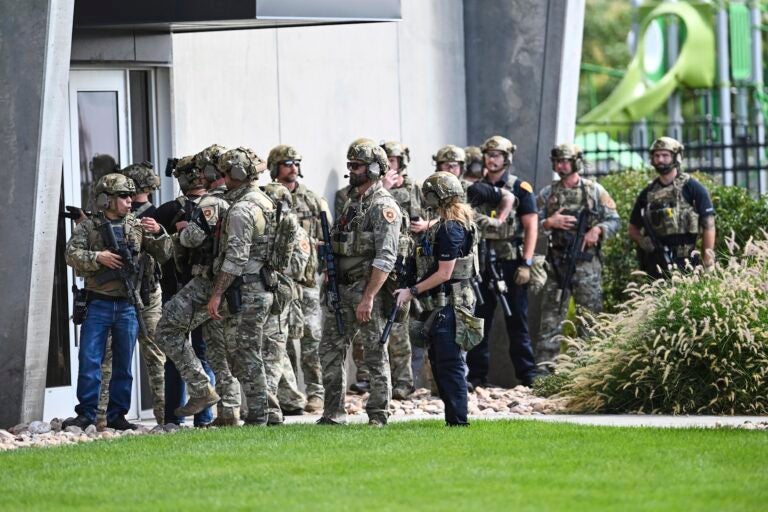 Law enforcement officials prepare to sweep a building