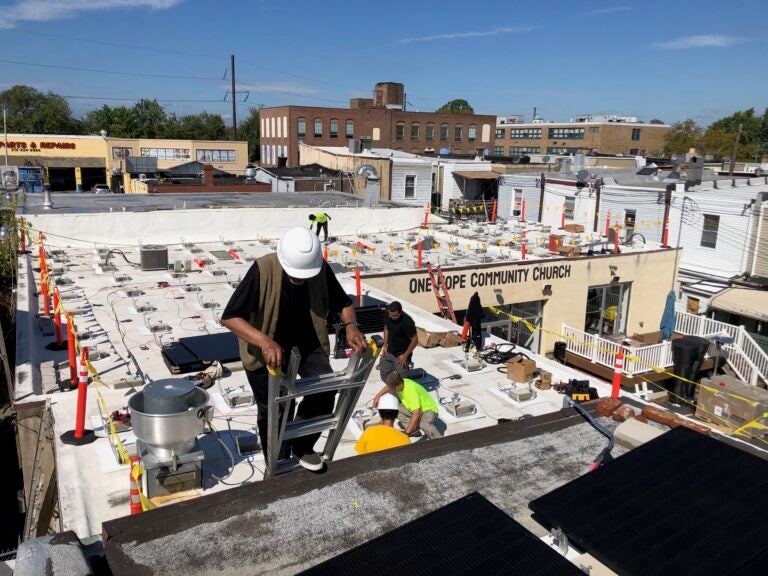 hunting-park-solar-one-hope-community-church-allen-drew-092925-01 Solar installers set up an array on the roof of One Hope Community Church in Hunting Park.
