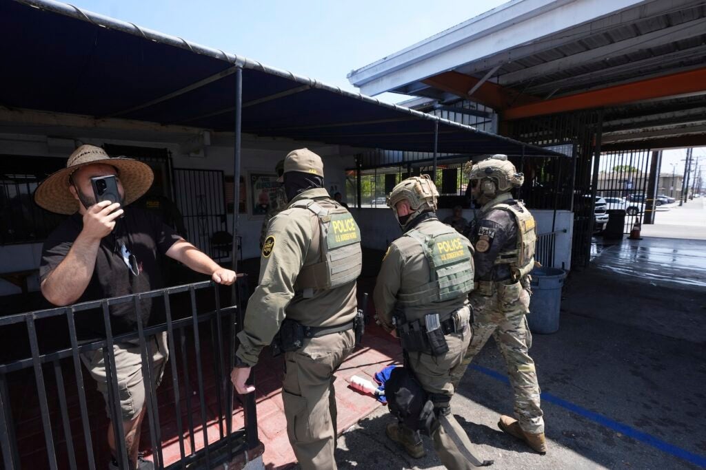 Immigration agents conduct an operation at a car wash