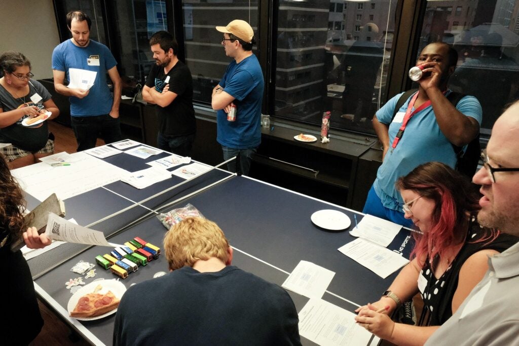 Several people are standing around a table