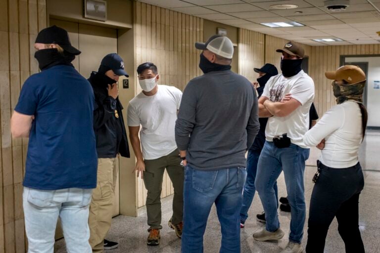 Federal agents patrol the halls of immigration court at the Federal agents patrol the halls of immigration court