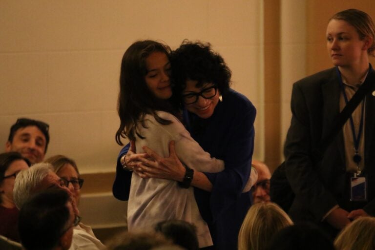 Supreme Court Justice Sonia Sotomayor hugging a child