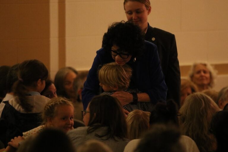 Supreme Court Justice Sonia Sotomayor hugging a child