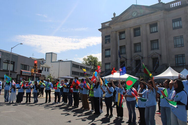 Children and community members paraded with flags from different countries in front of the municipal building at Upper Darby's International Festival