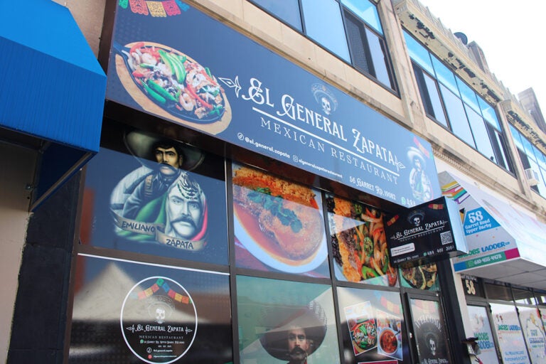 The window of a Mexican restaurant displays the dishes sold
