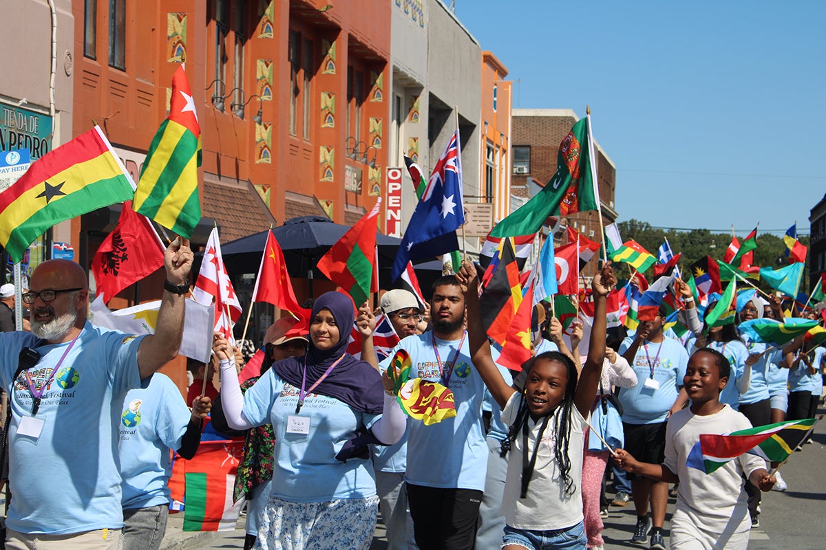 Children and community members paraded with flags from different countries in front of the municipal building at Upper Darby's International Festival
