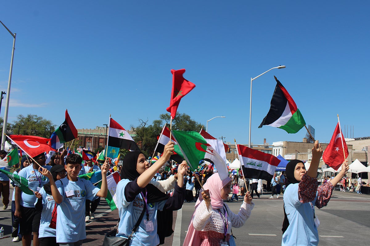 Children and community members paraded with flags from different countries in front of the municipal building at Upper Darby's International Festival