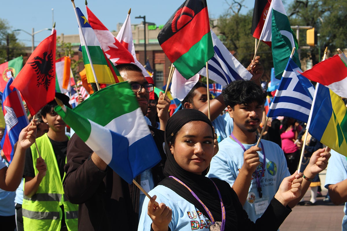 Children and community members paraded with flags from different countries in front of the municipal building at Upper Darby's International Festival
