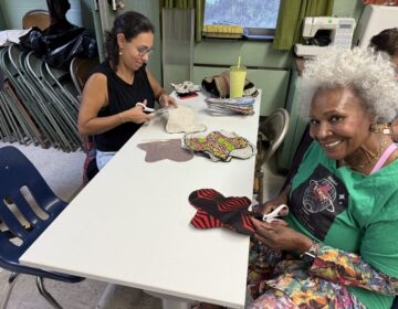 Volunteers with different skills sit at tables