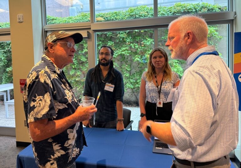 two reporters and an attendee at the WHYY open house event