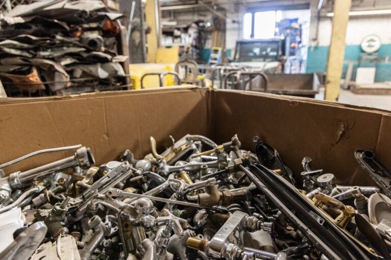 A large bin of metal knobs in the recycling center
