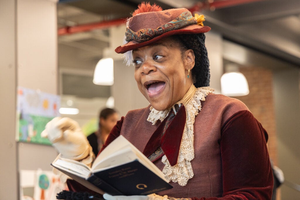 Sharia Benn talking to youth about activist Francis Harper