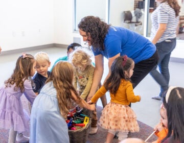 10 31 2025 k paynter 1200x music together princeton lab school-4 Norah Wasden cleans instruments with toddlers