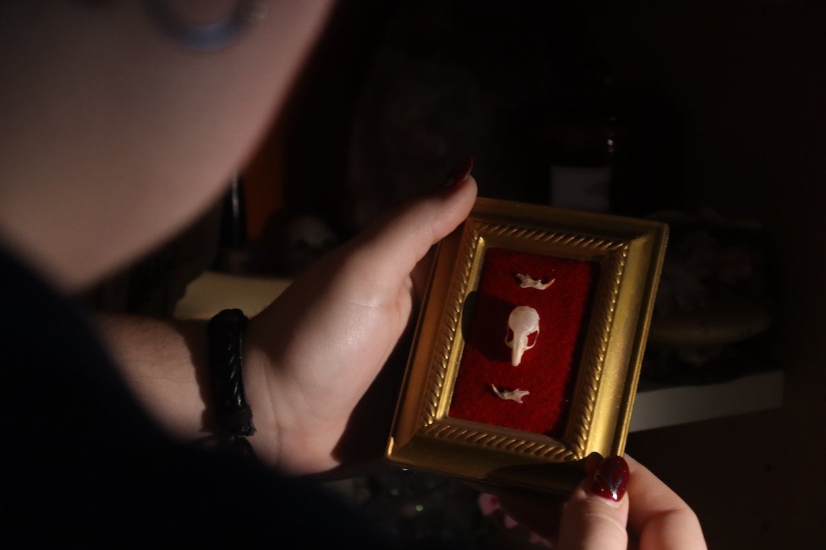 Artist Charlee Heinz holds one of their bone art creations. (Lise Peet)