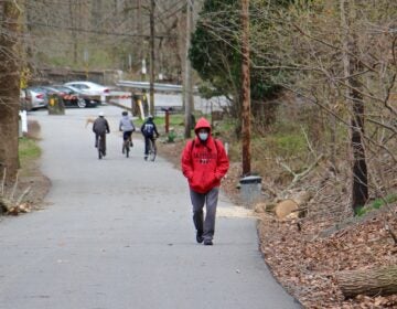 People walk along the multi-use trail at Ridley Creek State Park in Media, Pa.