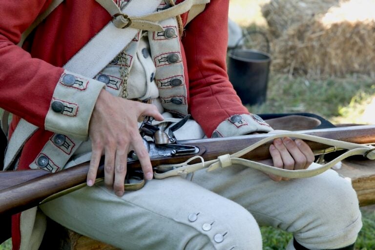 Reenactor shows details of revolutionary war weapon
