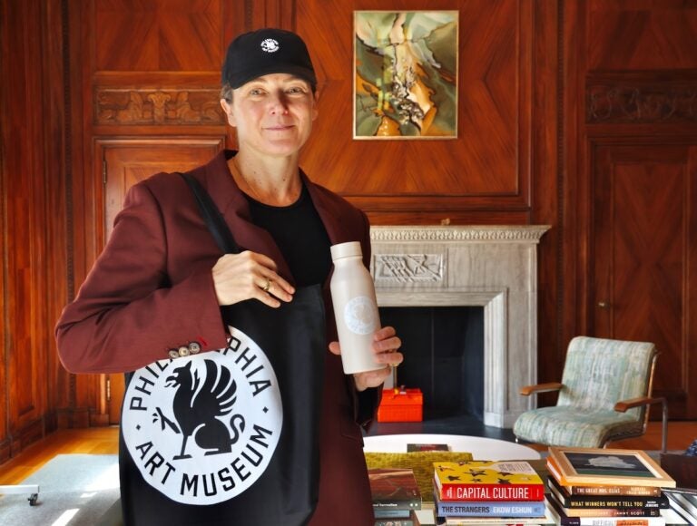 Sasha Suda with merchandise of new art museum logo