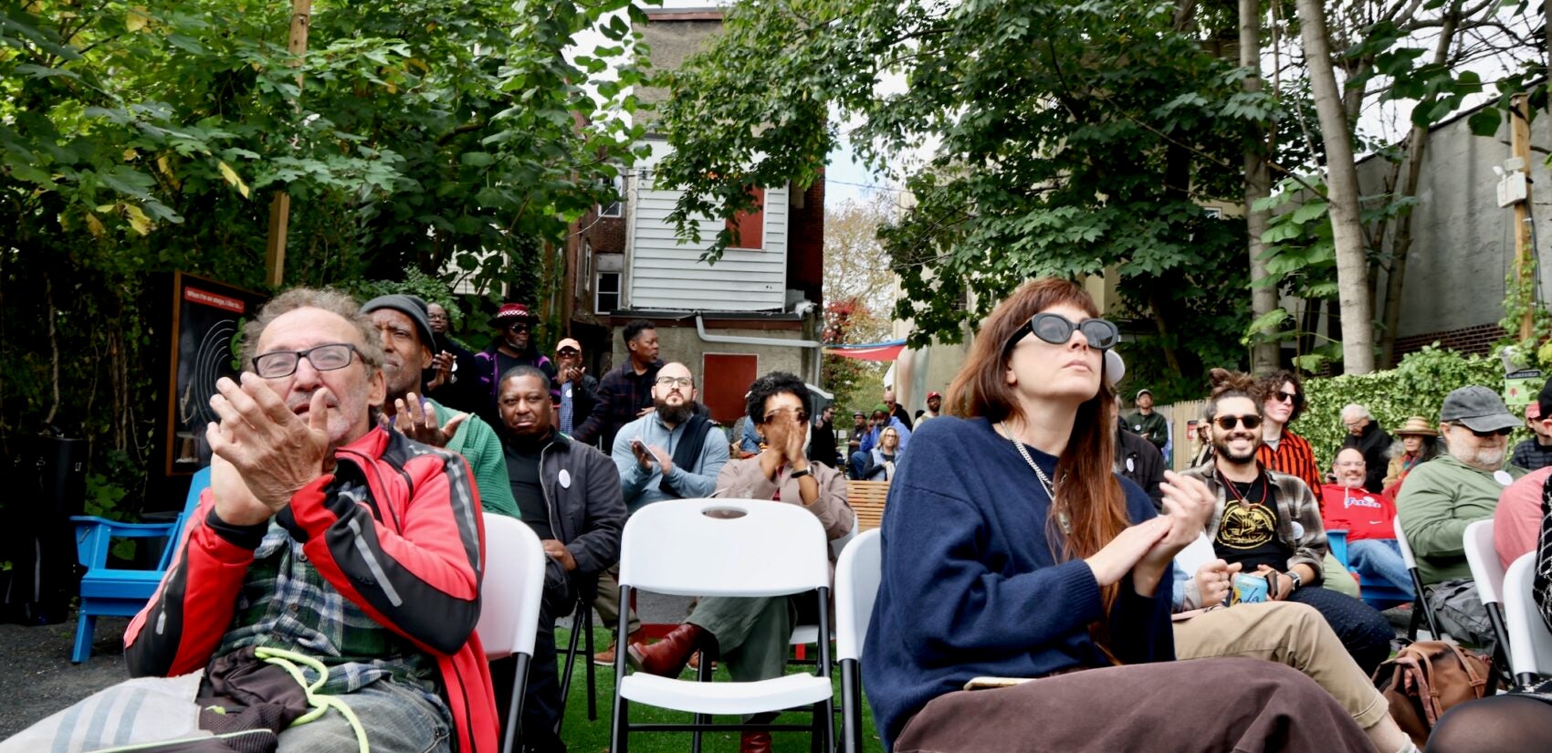 2025 10 10-e lee-philadelphia john coltrane house-audience Audience members applaud during a musical performance behind the John Coltrane House