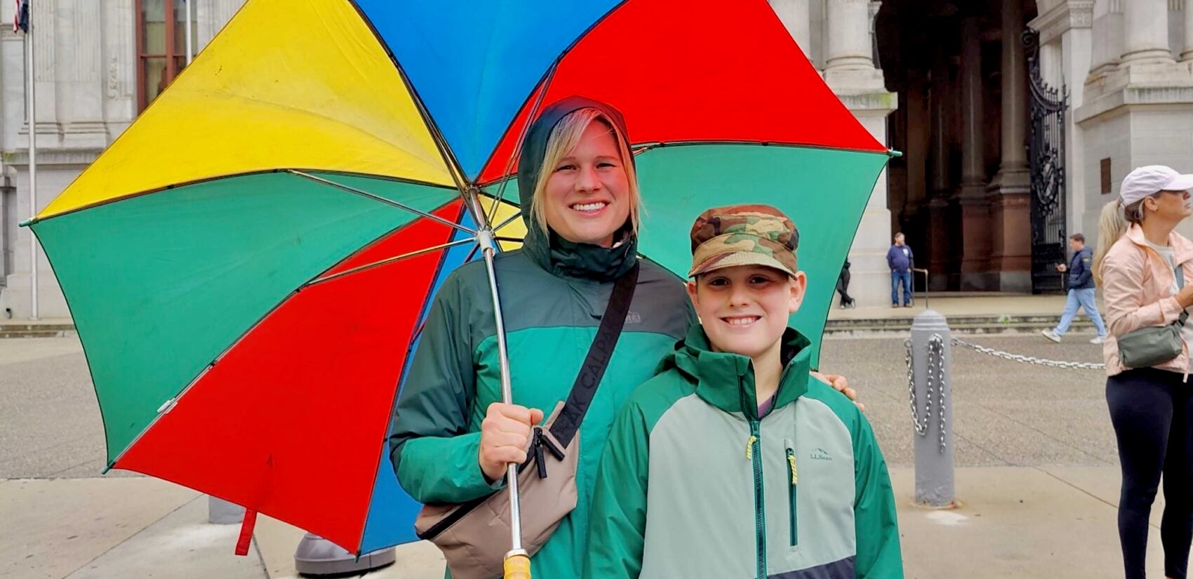 2025 10 13-p crimmins-meredith blair dominic blair-philadelphia-navy marines 250th parade spectators Meredith Blair and her son smile