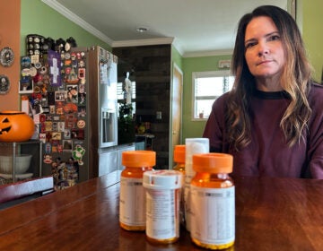 Local hair stylist Christine Meehan sits in front of her medication
