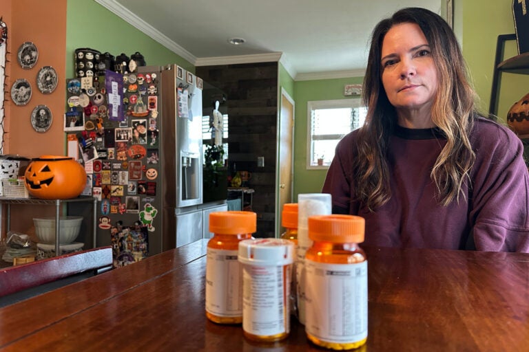 Local hair stylist Christine Meehan sits in front of her medication