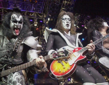 Kiss guitarist Paul Stanley, right, guitarist Ace Frehley, center, and bassist Gene Simmons play during the band's farewell concert