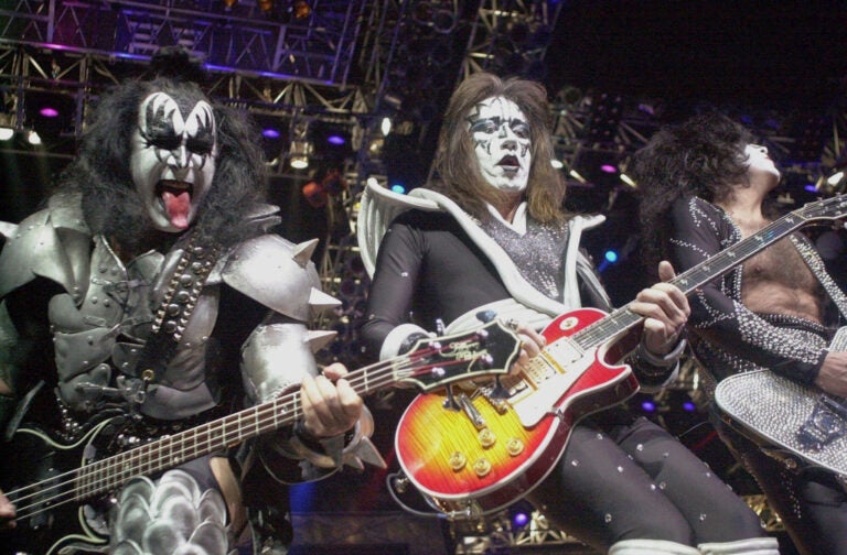 Kiss guitarist Paul Stanley, right, guitarist Ace Frehley, center, and bassist Gene Simmons play during the band's farewell concert