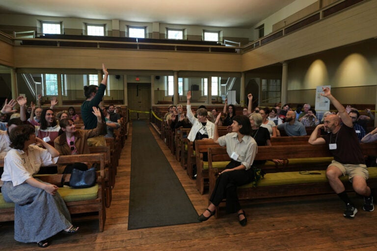 Quakers-Youthful Appeal Quakers raise their hands after a worship service at the historic West Room of the Arch Street Meeting House in Philadelphia