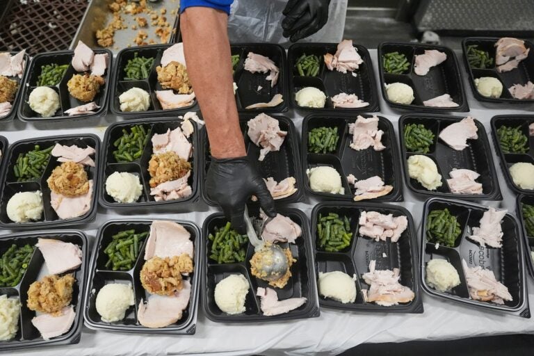 A volunteer prepares meals at the Philabundance Community Kitchen in Philadelphia, Thursday, Oct. 30, 2025.