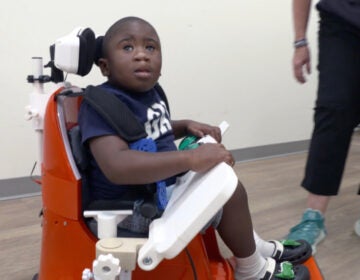 YOK Little boy in assistive device