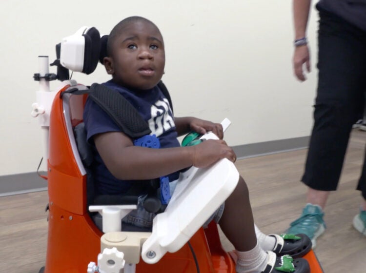 YOK Little boy in assistive device