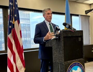 carney-wilmington-s-mueller-2025-10-30 John Carney speaking at a podium during a press conference