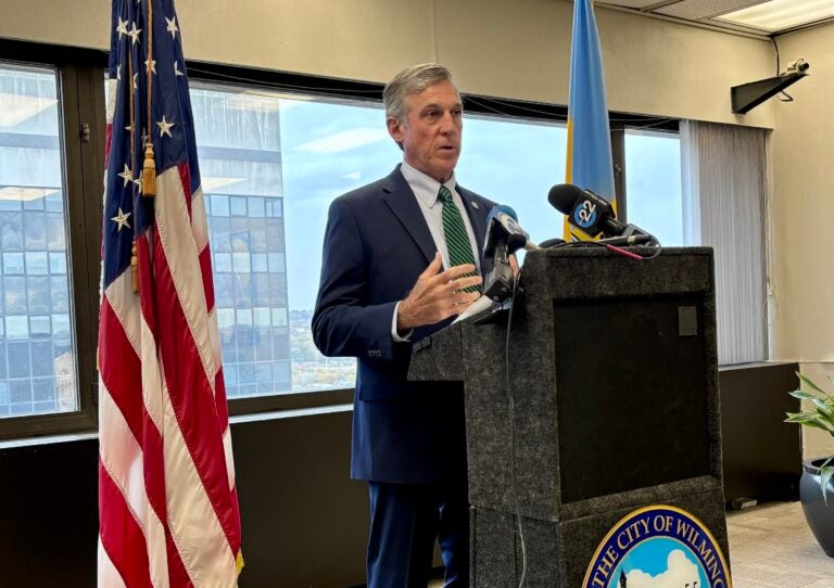 carney-wilmington-s-mueller-2025-10-30 John Carney speaking at a podium during a press conference