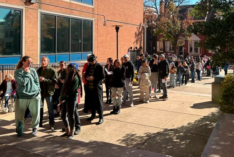 People wait in line outside the Bucks County government building to apply for an on-demand mail ballot on the last day to request one in Doylestown, Pa., Tuesday, Oct. 29, 2024.