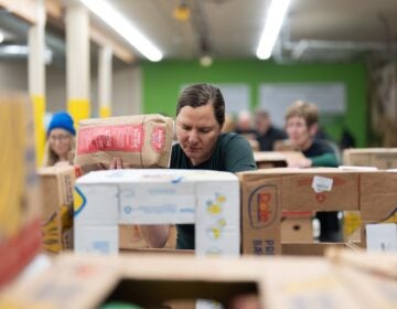 APTOPIX Government Shutdown Food Aid People working sorting food at a food bank