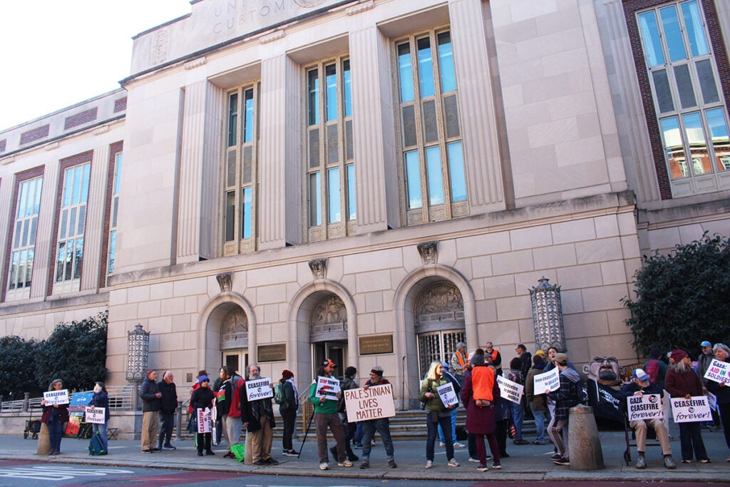 Dozens of people gather outside of Sen. John Fetterman's Old City office, holding signs calling for an end to the War in Gaza