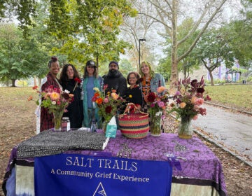 Salt Trails Philly organizer pose for a photo in front of a table