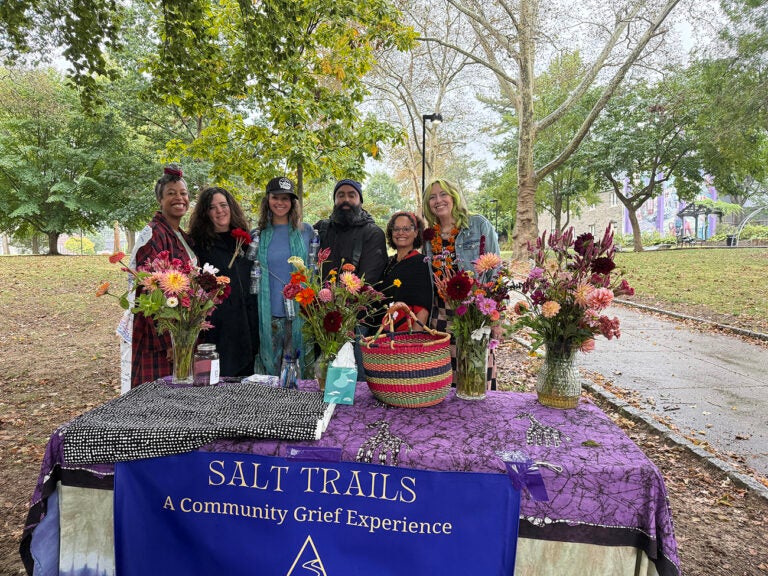 Salt Trails Philly organizer pose for a photo in front of a table