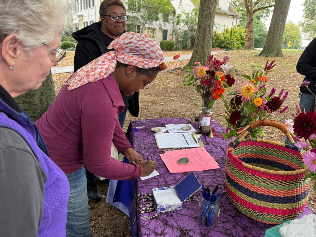 Attendees of the "grief processional" fill out cards that represent what they are grieving