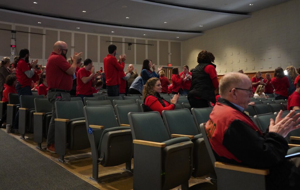Haverford educators give a standing ovation to a member of the audience during public comment at a school board meeting on Oct. 9, 2025.