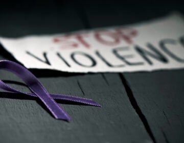 A purple ribbon for the awareness about the unacceptability of the violence against women