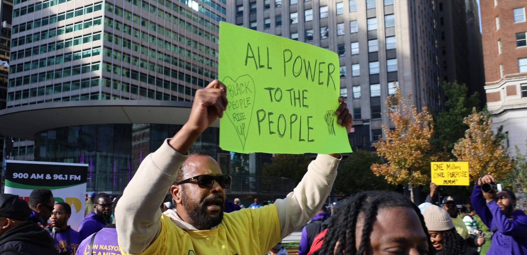 million-man-march-philadelphia-2025-10-26-1 a Philadelphian holds a sign reading ALL POWER TO THE PEOPLE BLACK PEOPLE RISE UP