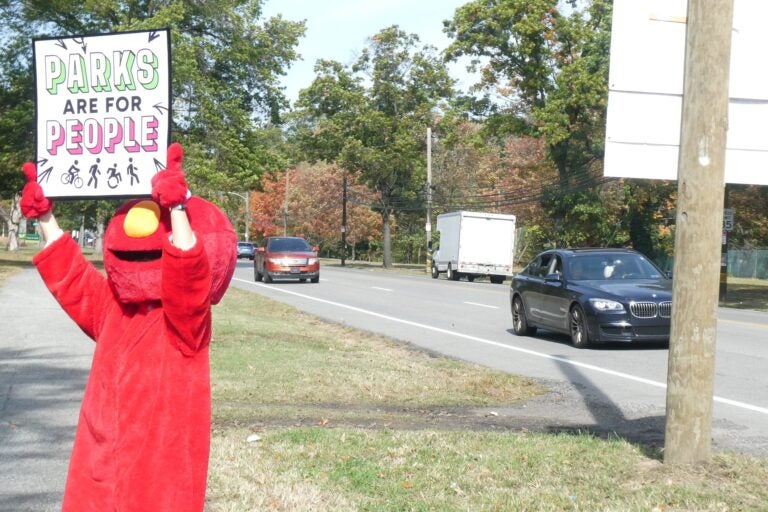 Elmo holds a sign reading PARKS ARE FOR PEOPLE